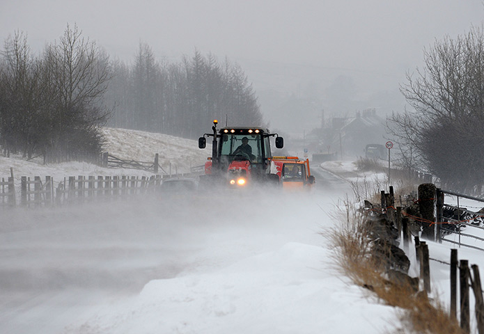 Uk snow: A tractor clears drifting snow from the A6 road near the town of Buxton