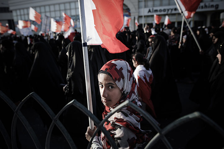 24 hours: A Bahraini girl holds a national flag during a protest