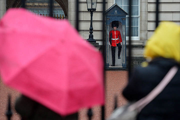 24 hours: Tourists watch a soldier from the 1st Battalion Welsh Guards