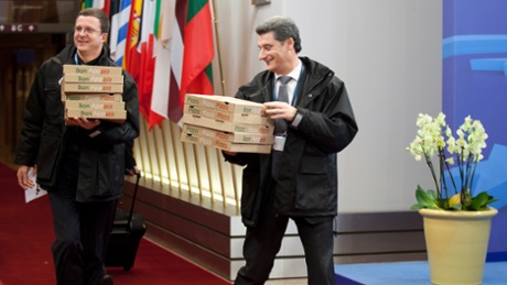 Personnel carry in boxes of pizza to the European Council building as an emergency eurogroup meeting takes place in Brussels on Sunday, March 24, 2013.