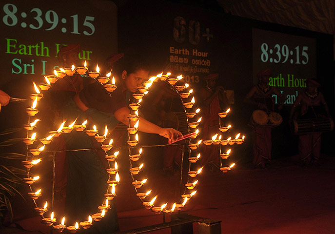 WWF Earth Hour: A woman lights up oil lamp to mark Earth