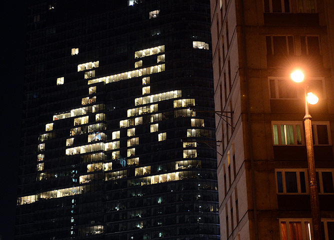 WWF Earth Hour: Some of the offices of a building have lights on to shape a bicycle, Warsaw