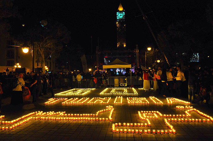 WWF Earth Hour: People standing next to candles arranged to read Tunisia 
