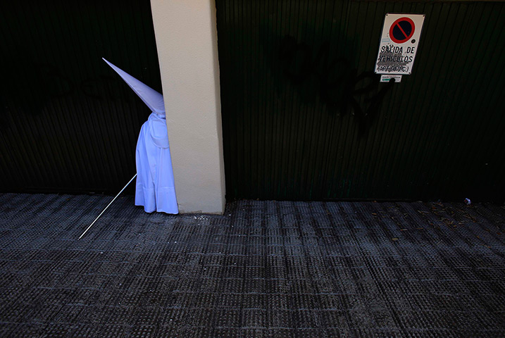 24 hours in pictures :  penitent is seen before the procession of 