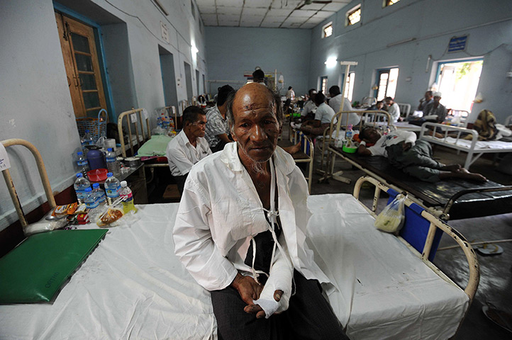 Burma violence: 23 March: An injured Muslim man sits on a bed at a hospital