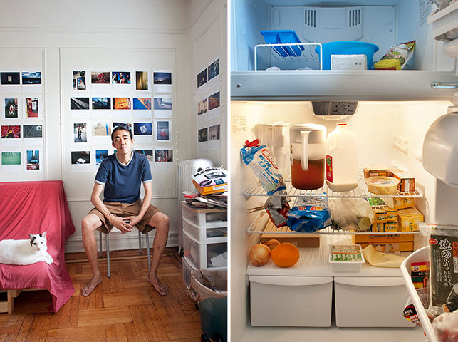 Big Picture - Fridges: young man dressed in shorts sits in front of photographs on wall