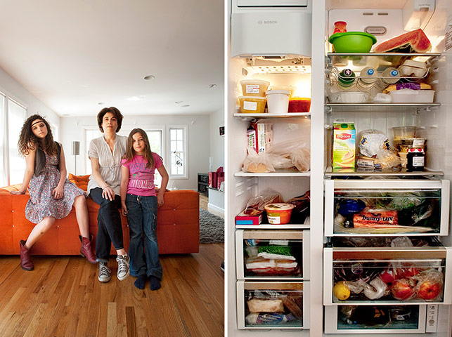 Big Picture - Fridges: woman with two children stand in front of orange sofa with pic of fridge