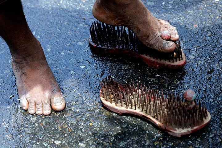 24 hours in pictures: A devotee wears a nailed footwear during the Tamil Hindu festival