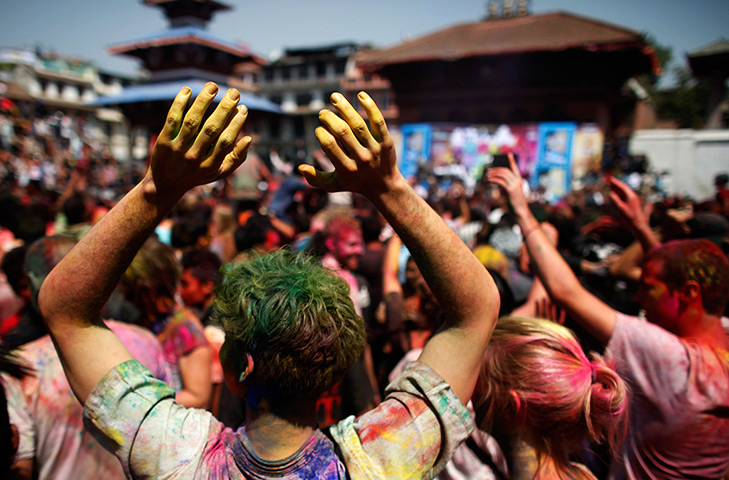 24 hours in pictures: Foreign tourists dance as they celebrate Holi