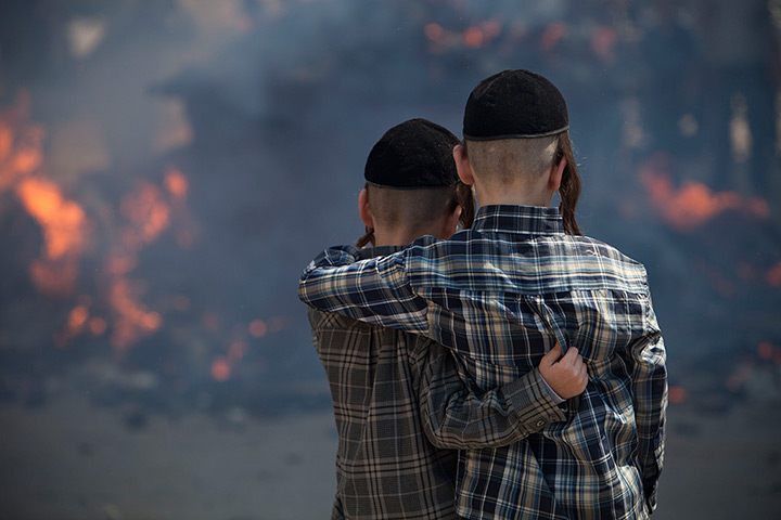 24 hours in pictures: Two boys watch as ultra-Orthodox Jewish men burn leavened items