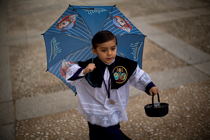 24 hours: Seville, Spain: An altar boy runs to the church 