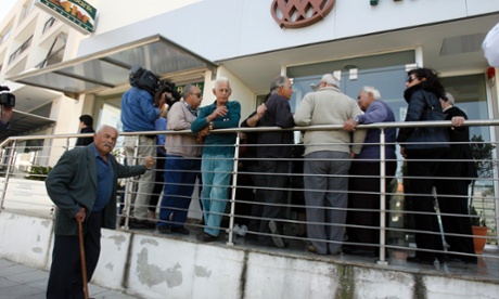 People wait outside a Coop bank branch in Nicosia, Cyprus, Thursday, March 28, 2013.