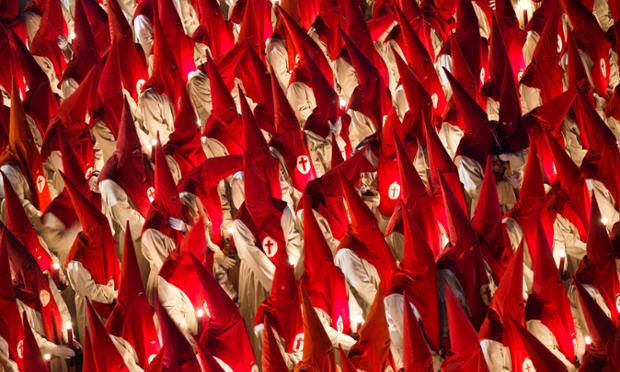 Penitents of Santisimo Cristo de las Injurias brotherhood take part in a Holy Week procession in Zamora, northern Spain.