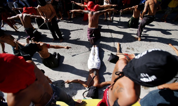 Filipino hooded penitents stop at a prayer station during Maundy Thursday rituals to atone for sins in Mandaluyong, east of Manila, Philippines. The ritual is frowned upon by church leaders in this predominantly Roman Catholic country.