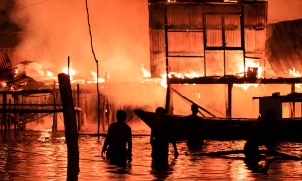 Locals watch their homes engulfed by flames as a fire destroys 400 wooden houses leaving 3,000 people homeless, Kota Kinabalu, Malaysia.