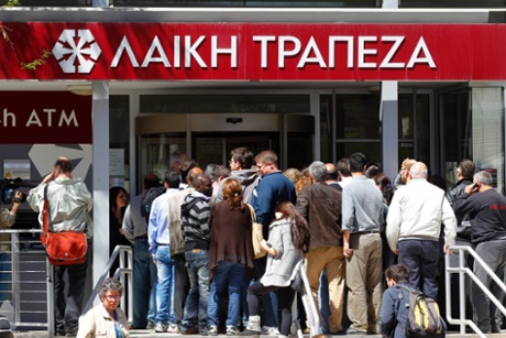 People wait to enter at a branch of Laiki Bank shortly after it opened in Nicosia March 28, 2013.