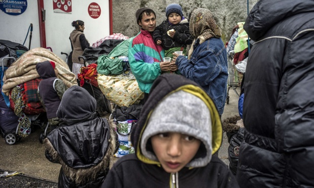 Roma people wait as bulldozers destroy their makeshift camp near Lyon. The European Association for the Defence of Human Rights said almost 12,000 ethnic Roma were evicted from camps across France in 2012 and French Interior Minister Manuel Valls announced he will continue the dismantling of camps.