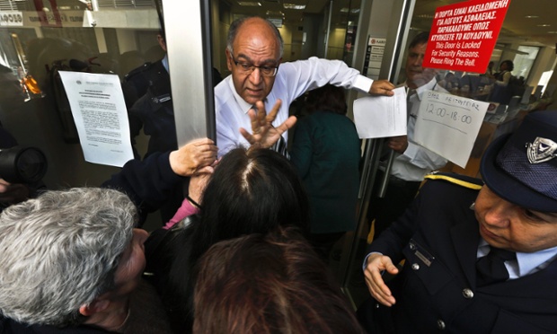 A tough day for the bank managers of Cyprus as they try to calm people as they wait for the banks for open.