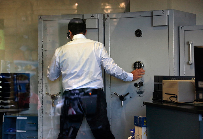 Cyprus banks: An employee opens a safe inside a Bank of Cyprus