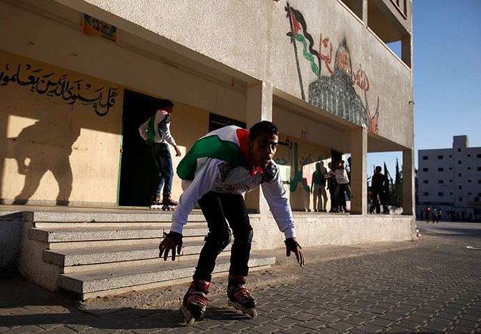 24 hours: Rafah, Gaza Strip: A Palestinian youth draped in a flag