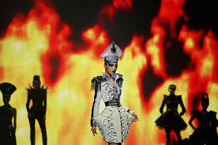 24 hours: Beijing, China: A model showcases designs on the catwalk 