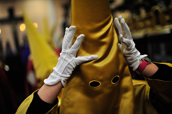 24 hours in pictures: Pamplona, Spain: Penitent prepares himself before to take part on the proce