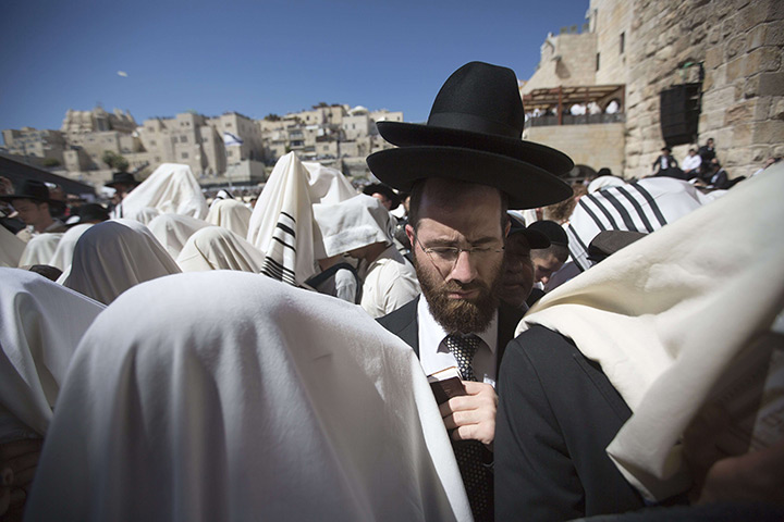 24 hours in pictures: Jerusalem : Jewish men draped in prayer shawls perform the Cohanim prayer (