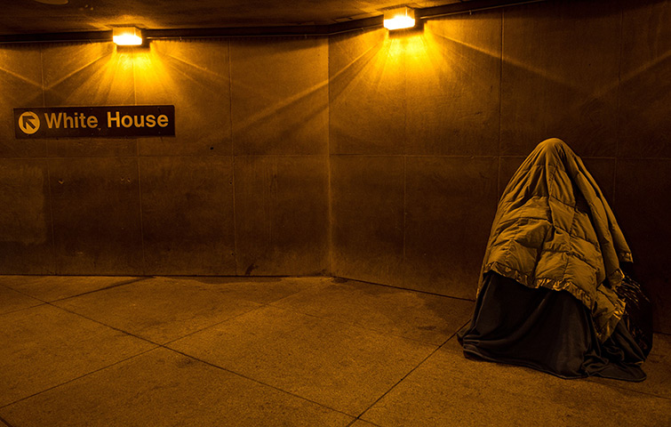 24 hours in pictures: Washington, USA: A homeless person covered in blankets sleeps at the entran