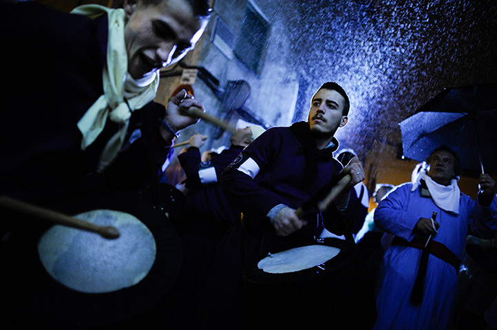 24 hours in pictures: Cuenca, Spain: Penitents take part in the procession of the 