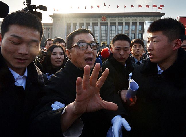 24 hours in pictures: Jackie Chan leaves the opening session of the Chinese People's Political Consultative Conference in Beijing, China