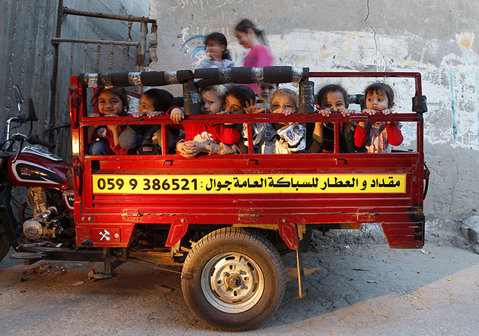 24 Hours: Palestinian children sit in the back motorcycle in the Shati refugee camp