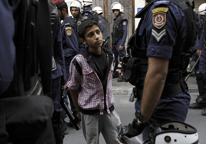 24 Hours: Riot police arrest a Bahraini boy during anti-government protests