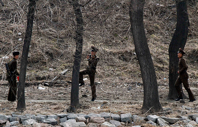 24 Hours: Soldiers on the banks of Yalu River, near the North Korean town of Sinuiju