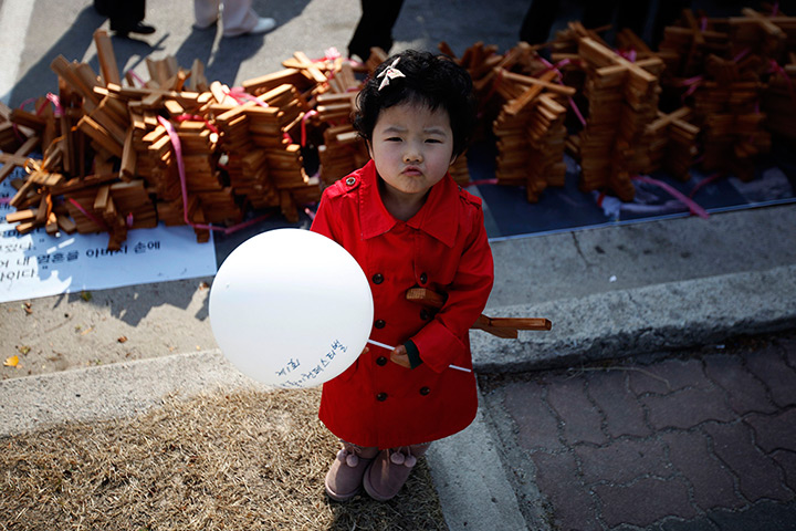Easter Sunday: A girl stands in front of crosses before a procession to celebrate Easter