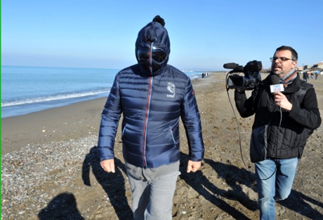 Italian comedian, blogger and political leader of the Five Stars Movement (M5S) Beppe Grillo is questioned as he runs on the beach on March 3, 2013 in Marina di Bibbona, near Livorno, Italy. 