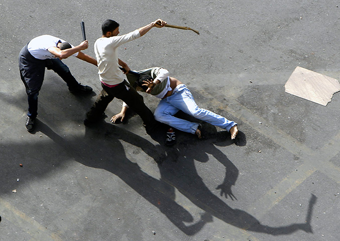 24 hours in pictures: Plain clothes police beat an anti-government protester in Tahrir Square 