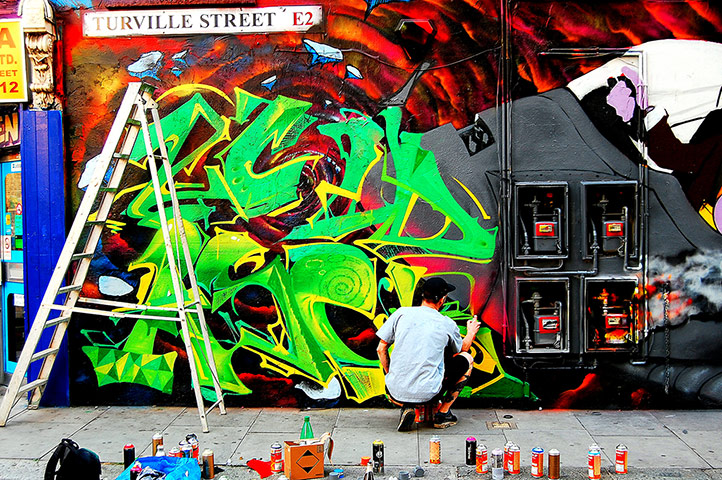 Your Pictures - Transform: man on street making graffitti art on wall