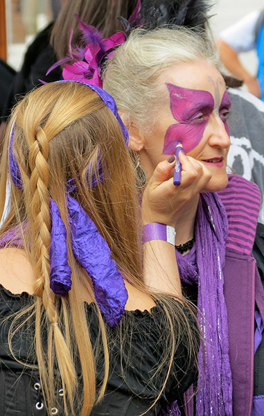 Your Pictures - Transform: girl applying purple make-up to older woman
