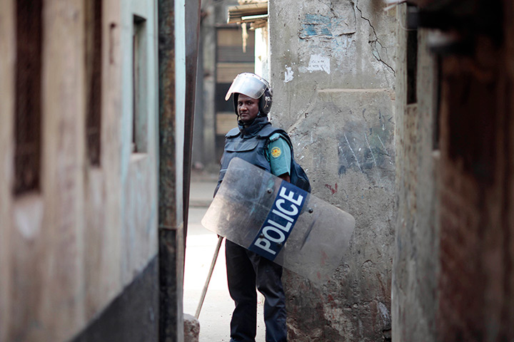 24 hours in pictures: A Bangladeshi police officer stands guard during a nationwide strike