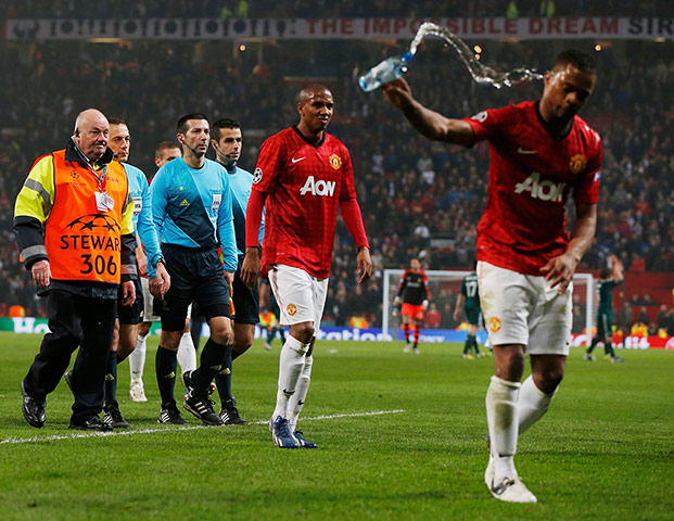 United v Real Madrid 2: Referee Cuneyt Cakir is escorted off the pitch 
