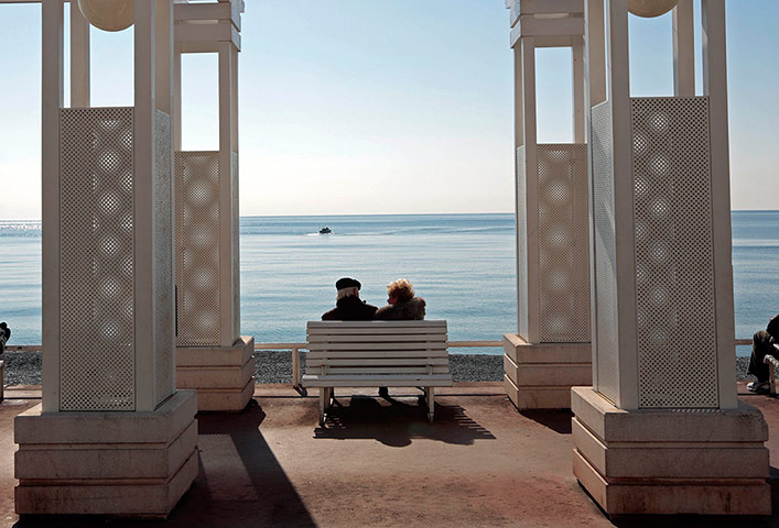 24 hours in pictures: A couple sit on a bench in Nice