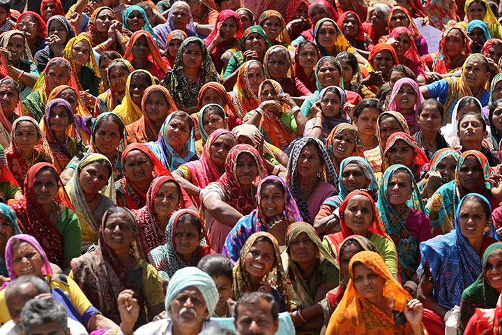 24 hours in pictures: Indian villagers listen to a leader