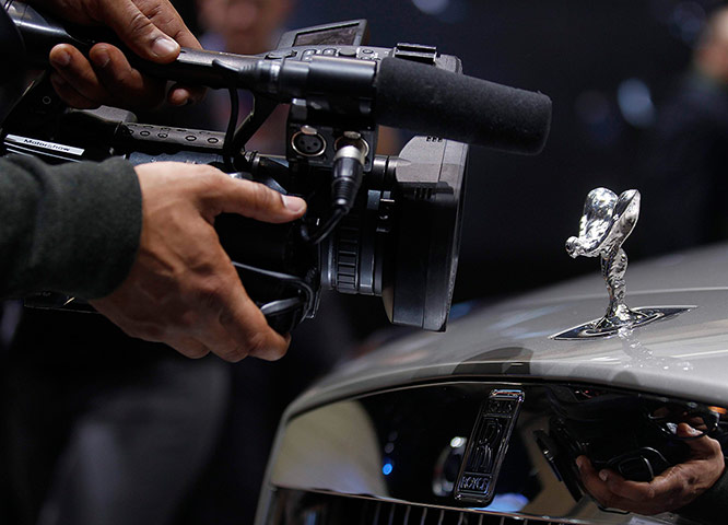 24 hours in pictures: A cameraman films the Spirit of Ecstasy mascot