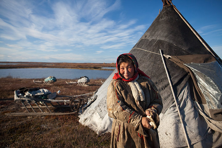 A Nenets woman outside her chum, or teepee, in Siberia’s Yamal Peninsula