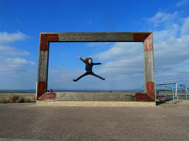 Inpics-leap: girl jumping inside frame against blue sky