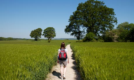 Young woman walking through a field