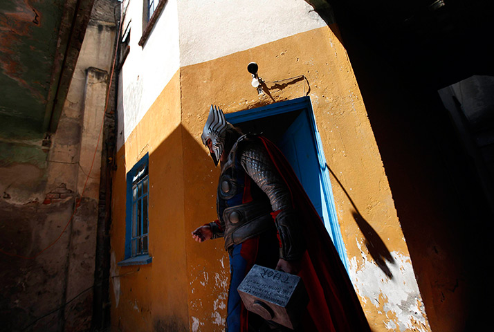 24 hours in pictures: Street artist Ruben Oviedo, 40, dressed as comics superhero Thor