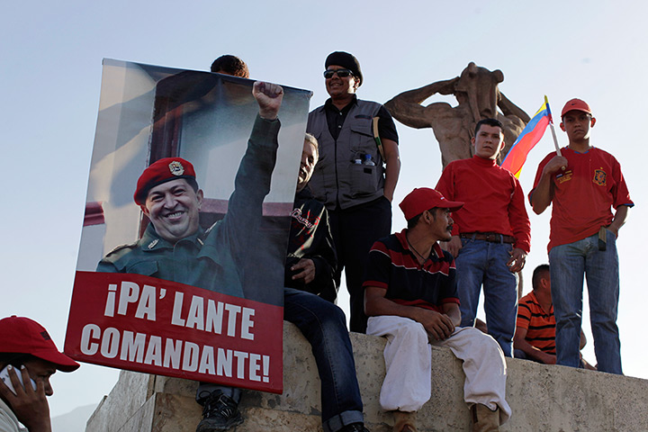 Hugo Chavez funeral: Supporters hold a poster reading in Spanish 