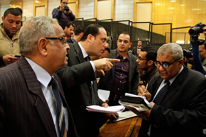 Lawyers for the defendants confer after the Port Said criminal court gave its verdict