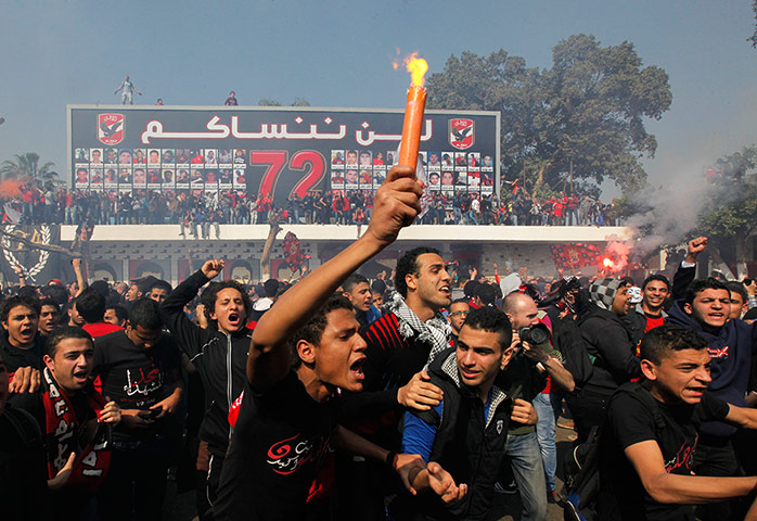 Fans of al-Ahly celebrate outside their stadium in Cairo, Egypt